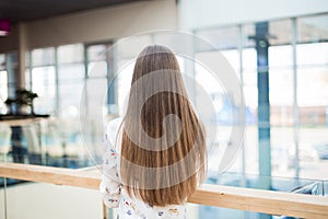 Woman with long natural hair standing backwards