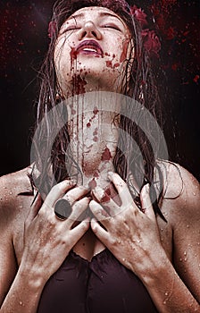 Woman with a long neck, beautiful shoulders, wet hair, tragic expression on his face and a drop of blood