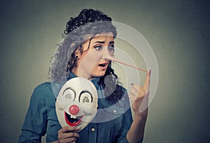 Woman with long nose and clown mask. Liar concept