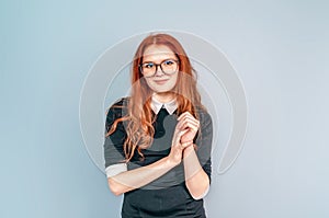 Woman with long red hair in glasses. Teacher. Education, teaching. Librarian