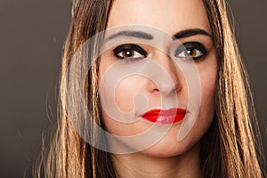 Woman long straight hair dark makeup red lips on gray