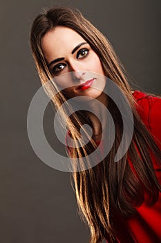 Woman long straight hair dark makeup red lips on gray