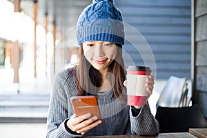 Woman look at cellphone at outdoor cafe