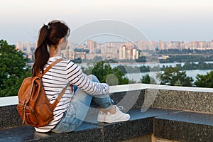 The woman look at the city panorama