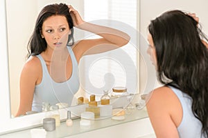 Woman look at herself bathroom mirror reflection photo