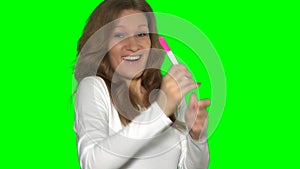 woman look at pregnancy test enjoying surprise result. Chroma key screen. 4K