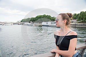 Woman look at seine river in paris, france. Sensual woman in sunglasses on bridge on summer day. Vacation and wanderlust concept