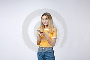 Woman look and texting with friend on mobile phone isolated over grey background.