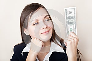 Woman is looking at 100 dollars banknote