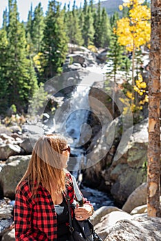 Woman looking at Alberta Falls in Rocky Mountain National Park