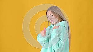 Woman Looking approvingly at camera showing thumbs up