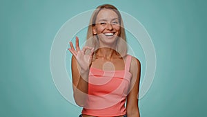 Woman looking approvingly, showing ok approve feedback gesture like sign positive something good