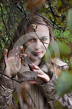 Woman Looking through Autumn Branches