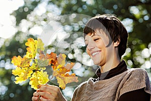 Woman looking at autumn leaves