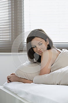 Woman Looking Away While Lying In Bed