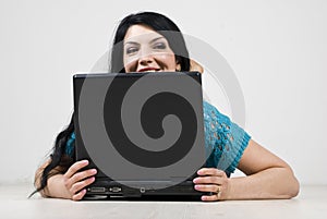 Woman looking away and spy behind laptop