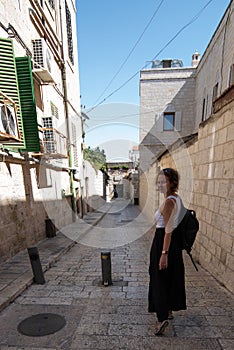 Woman looking back while walking on the streets of Jerusalem