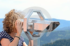 Woman looking through a binocular telescope