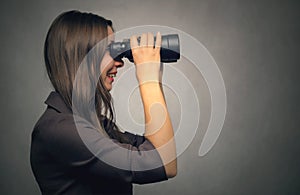 Woman looking in binoculars.