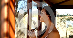 Woman looking through binoculars on safari vacation 4k