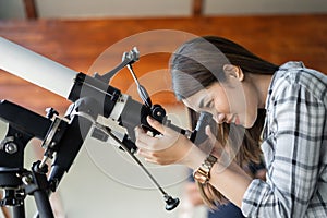 Woman looking through telescope