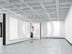Woman is looking at a blank picture in an art gallery