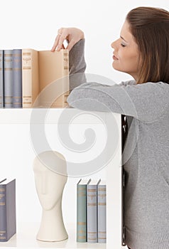 Woman looking at books on shelf