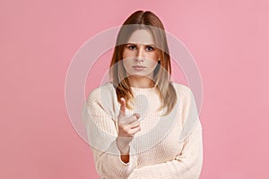 Woman looking at camera and blaming warning you with raised finger, showing admonishing gesture.