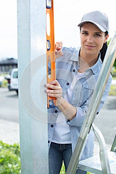 woman looking at camera while holding sprit level