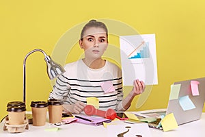 Woman looking at camera showing growth diagram, financial and economic growth of his business.