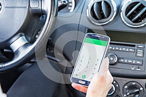 Woman looking at cell phone in car