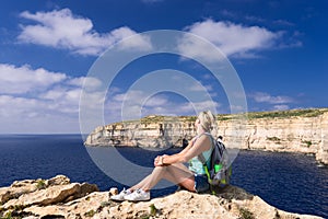 Woman looking at coastline near Azure Window on Gozo Island