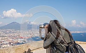 Woman looking at coin operated binocular