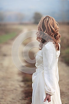 Woman looking at country road