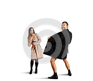 Woman looking at crazy man in coat