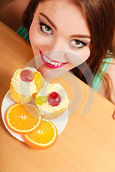 Woman looking at delicious sweet cake. Gluttony.