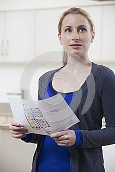 Woman Looking At Details For Property She Hopes To Buy photo