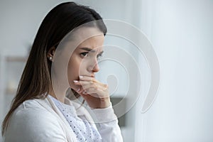 Woman looking in distance feels upset having life troubles