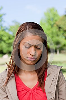 Woman looking downwards with a disappointed expresssion