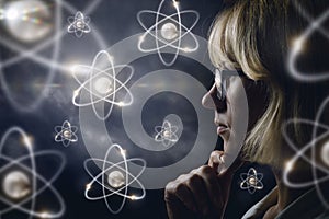 Woman looking explores atoms .