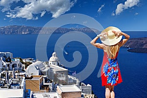 A woman looking from Fira of Santorini island, Greece