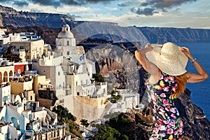 A woman looking at the Fira of Santorini island, Greece