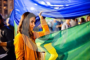 Woman looking through flags, Bucharest, Romania