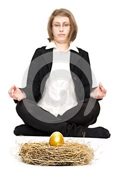 Woman looking at a golden egg.