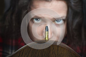 Woman looking at a guns bullet