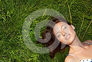 Woman looking happy and smiling on grass