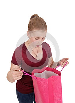 Woman looking into her empty shopping bag