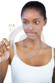 Woman looking at her eyelash curler