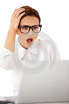 Woman looking at her laptop in horror