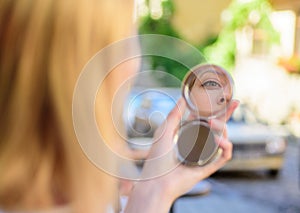 Woman looking in her pocket mirror selective focus defocused background. Check if everything is right. Beauty treatment